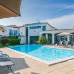 Slide Unheated outdoor swimming pool with heated paddling pool, surrounded by sun loungers at the Les Carrelets residence in Saint-Palais-sur-Mer