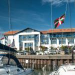 Slide Exterior façade of the Sokoburu residence in Hendaye overlooking the port under a beautiful blue sky