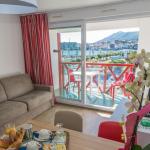 Slide Living room with sofa bed and balcony overlooking the port in an apartment of the Sokoburu residence in Hendaye