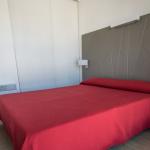 Slide Bedroom with a double bed in an apartment of the Sokoburu residence in Hendaye overlooking the patio