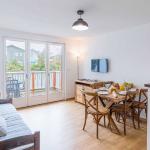 Slide Living room equipped with a television and opening onto an outdoor area in an apartment at Les Rives Marines in Le Teich