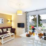 Slide Living area of a cottage with lounge corner and dining space at the Domaine de la Baie