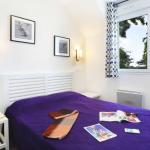Slide Bedroom with a double bed and bedside tables in a cottage at the Domaine de la Baie