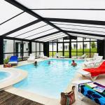 Slide Heated indoor swimming pool with jacuzzi at the Domaine de la Baie