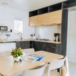 Slide Living room opening onto a fully equipped kitchen in one of the cottages at Le Tropicana Campsite in Saint-Jean-de-Monts, Vendée