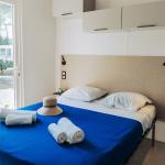 Slide Bedroom with double bed and views over the estate in the four-person cottages at Tropicana Campsite in Saint-Jean-de-Monts, Vendée