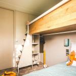 Slide Bedroom with two single beds and an upper bunk in the Premium 6-person cottage at Les Places Dorées***** campsite
