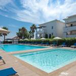 Slide Central outdoor swimming pool and paddling pool with sun loungers at the Sognu Di Rena residence in Moriani-Plage