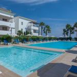 Slide Central aquatic area accessible through the lush gardens of the Sognu Di Rena residence in Moriani-Plage