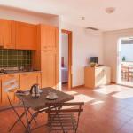 Slide Spacious open-plan kitchen overlooking the living room in one of the apartments at the Sognu Di Rena residence in Moriani-Plage