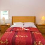 Slide Bedroom with a double bed and two bedside tables in a Fontenelles house in Vendée