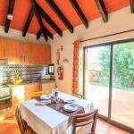 Slide Open-plan kitchen leading onto the dining area with direct access to the outside of the villa at Pedras del Rei
