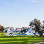 Slide Distant overall view of the aquatic area of the Pedras del Rei residence with white accommodation buildings in the background