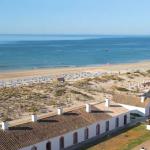 Slide Santa Luzia beach in Portugal with sun loungers