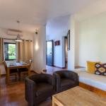 Slide Espace salon avec canapé et fauteuils et salle à manger en arrière-plan dans une villa de Pedras da Rainha au Portugal