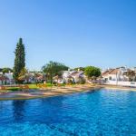 Slide Large unheated outdoor swimming pool with sun loungers and a paddling pool area at Pedras da Rainha, Portugal