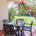 Slide Covered terrace with outdoor lounge furniture in a villa at Pedras da Rainha