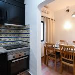 Slide Fully equipped kitchen open to the dining room within accommodation at the Pedras da Rainha resort