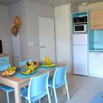 Slide Living area with dining space and open-plan kitchen in a holiday cottage at La Grenadine residence