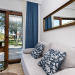 Slide Living area of the Sveta Ana Lodges cottages opening onto a large wooden terrace sheltered from the sun