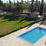 Slide A holiday of complete privacy and tranquillity at the Sveta Ana Lodges cottages, featuring a large swimming pool