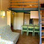 Slide Living area of a cottage at Résidence Vorey-sur-Arzon with sofa bed, open-plan kitchen, and duplex layout