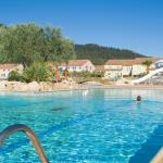 Slide Outdoor swimming pool with sun loungers and bridge over the water at Le Clos des Oliviers residence