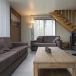 Slide Relaxation area with a lounge equipped with a wood-burning stove for optimal comfort at Golden Lakes Village Estate