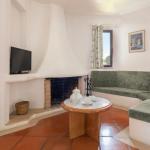 Slide Living area with sofa, fireplace, and television in the standard accommodations at Balaia Golf Village