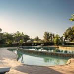 Slide Relaxation area with twin pools, sun loungers, and parasols at Balaia Golf Village