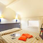 Slide Bedroom with one double bed and two wall-mounted bedside lamps.