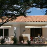 Slide Exterior of a holiday home at the Les Sables Vignier residence with outdoor garden furniture