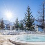 Slide Heated indoor swimming pool with sun loungers and mountain views at Les Terrasses de Veret Residence in Flaine