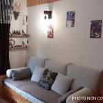 Slide Living room with a sofa bed, minimalist décor, and access to a balcony in the Valfréjus studios