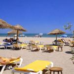 Slide Beach in Occitanie with sun loungers.