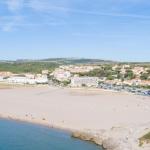 Slide Aerial view of the residence with the beach in the foreground in Occitanie.