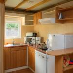 Slide Kitchen area opening onto the bunk bed room in the 6-person chalets at La Ferté-Imbault