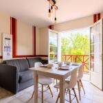 Slide Living room of a 4-person apartment with sofa and dining table at Les Collines Iduki