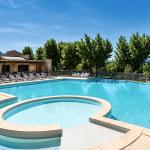 Slide Large outdoor swimming pool with paddling area at the Provence Country Club residence.