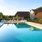 Slide Outdoor pool at Résidence Le Clos du Rocher with sun loungers