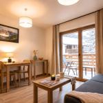 Slide Living room with sofa and table in a studio apartment at the Arya Living Stone residence