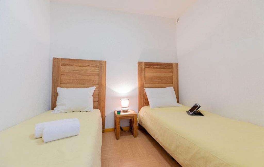 Slide Chambre avec lits simples d'un des logements