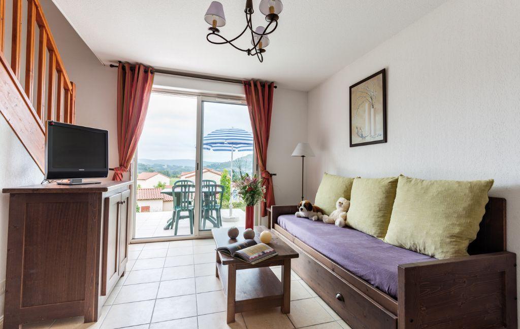 Slide Living room in the cottages at the Domaine des Cazlles in Cajarc with terrace view
