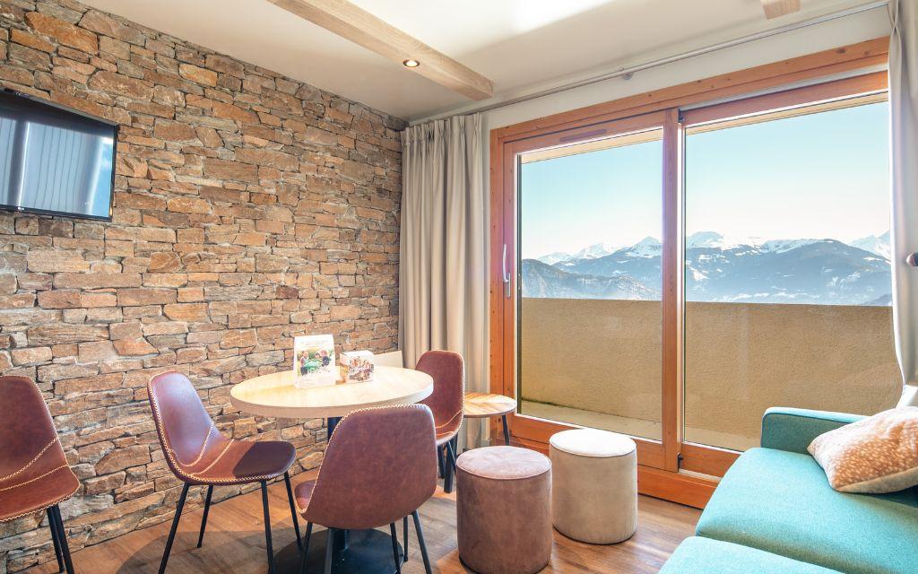 Slide Living room with sofa in a mountain apartment within the Le Beauregard residence