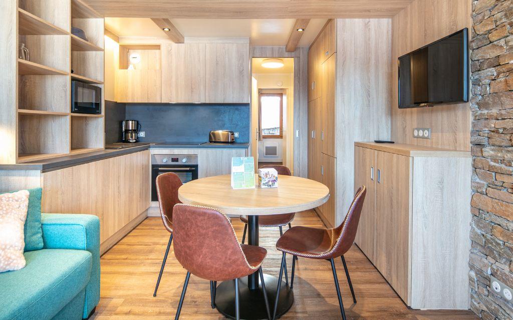 Slide Dining area with open kitchen and dining table at Le Beauregard residence