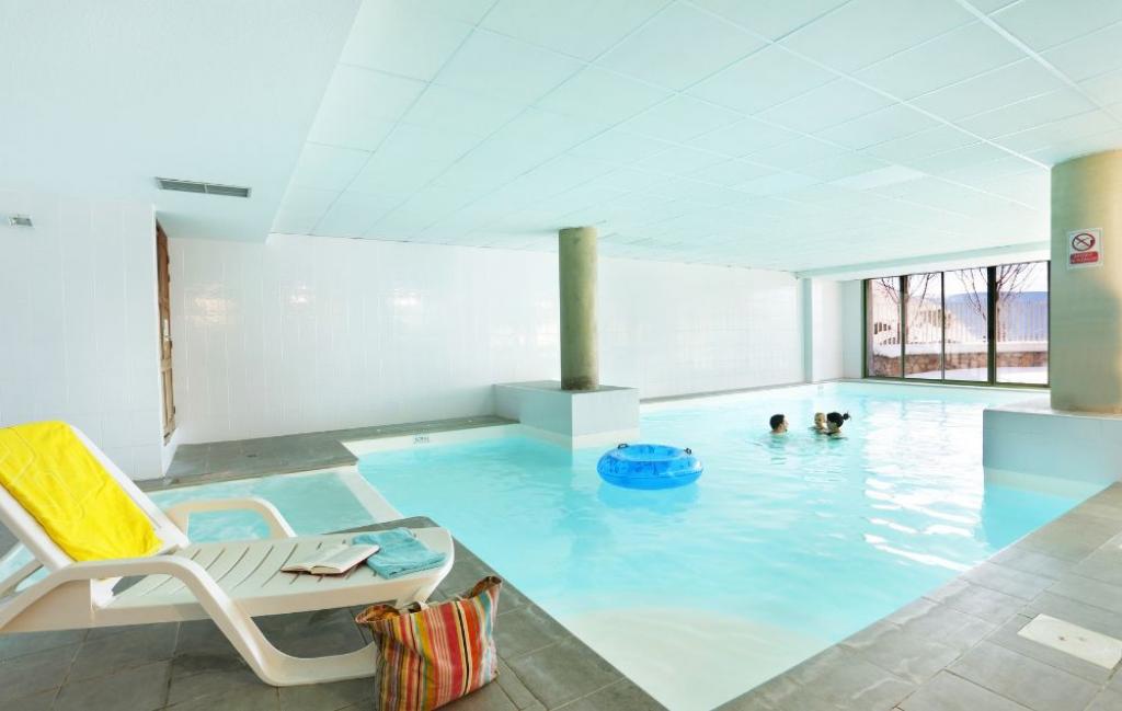 Slide Heated indoor swimming pool in the Les Chalets du Beleveder residence