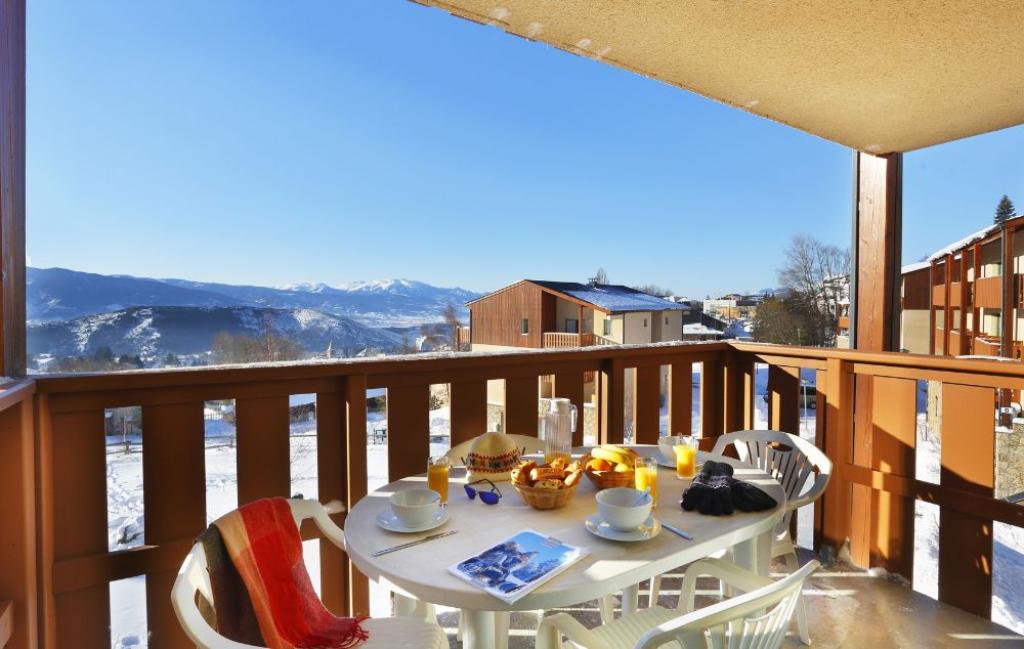 Slide Balcony with garden furniture and mountain views at Les Chalets du Belveder residence