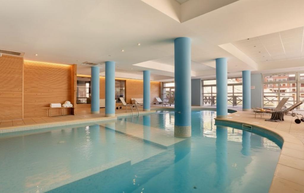 Slide Heated indoor swimming pool at Les Chalets du Verdon residence in La Foux d'Allos