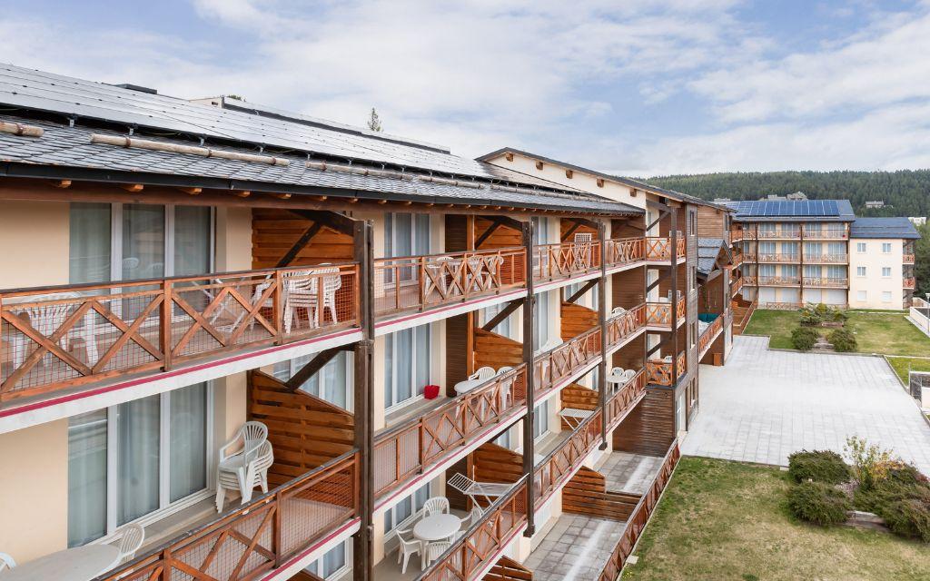 Slide Exterior of the Pyrénées 2000 residence with a close-up of the balconies in summer