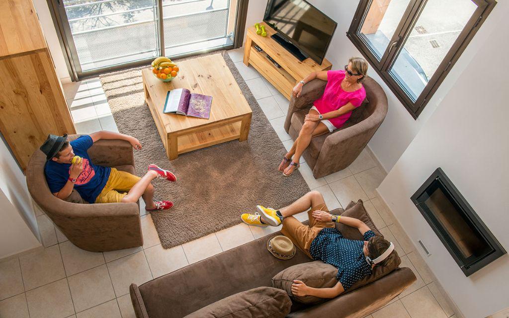 Slide Top view of a living room in an apartment at L’Écrin du Lac in Chorges